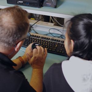 A man and a woman analyzing an electrical component